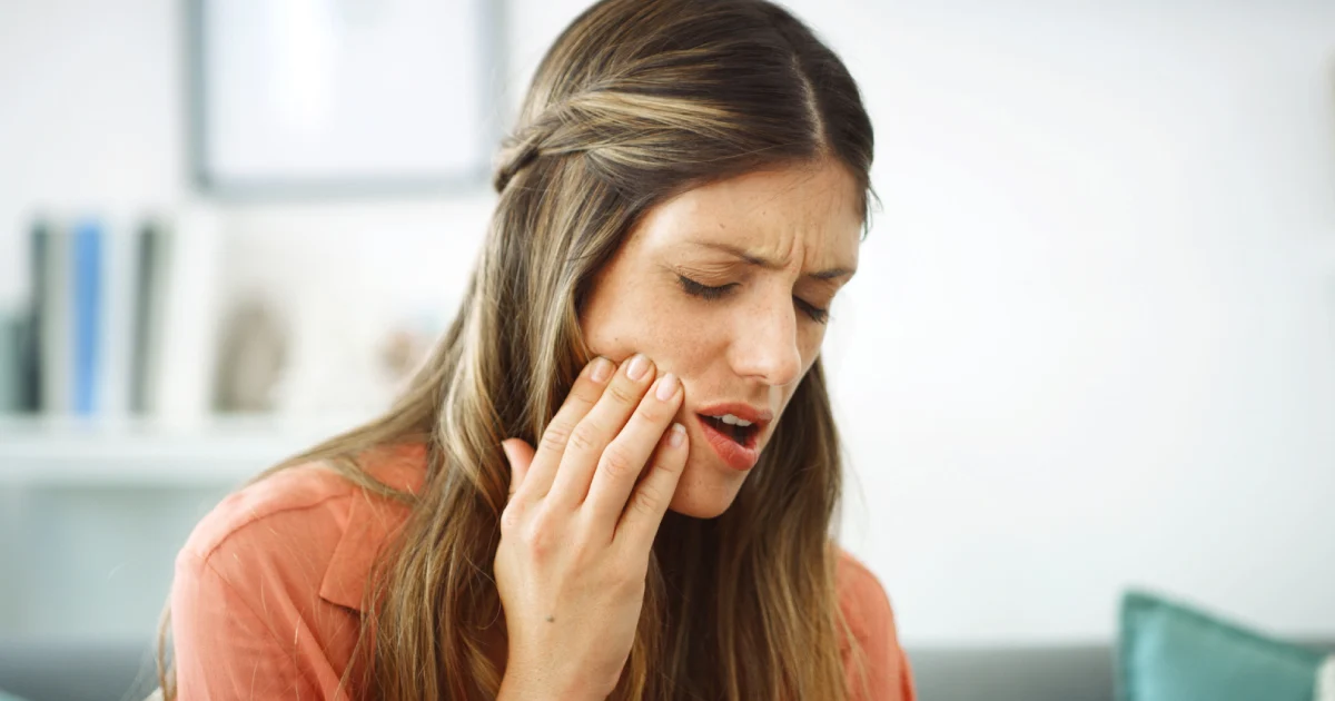 Woman experiencing TMJ jaw pain and discomfort – Salathe Dental